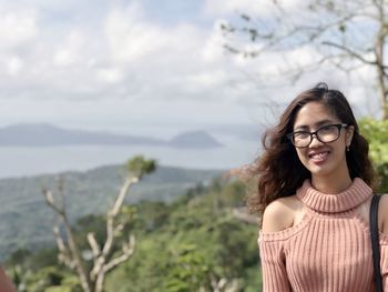 Portrait of smiling young woman standing outdoors