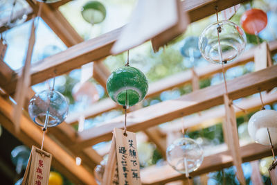 Low angle view of decorations hanging on glass