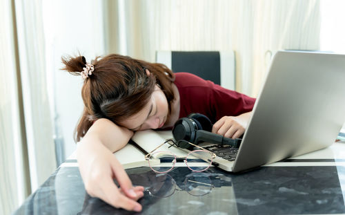 Woman using mobile phone at home