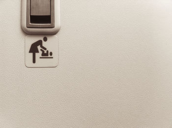 Close-up of arrow sign on wall