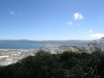 Scenic view of sea by city against sky