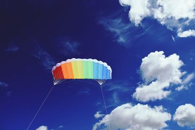 Low angle view of colorful kite flying in sky