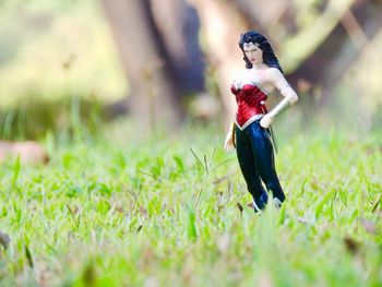 Woman standing on grass in field