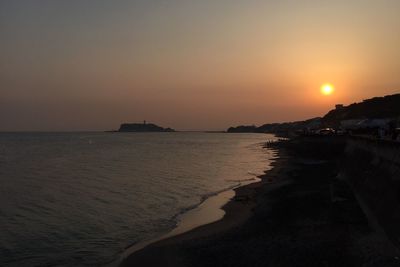 Scenic view of sea against clear sky during sunset