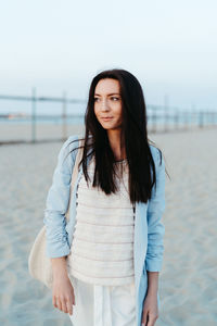 Portrait of a girl walking on the beach at sunset in catania, italy