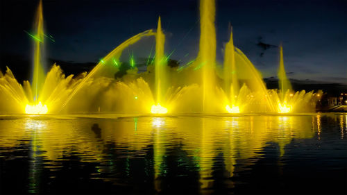 Scenic view of lake against sky at night