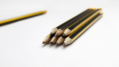 Close-up of pencils against white background