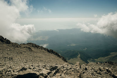 Aerial view of land and mountains against sky