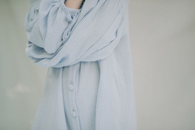 Midsection of woman standing against wall