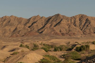 Scenic view of arid landscape against sky