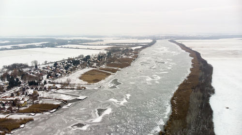 High angle view of frozen sea shore against sky