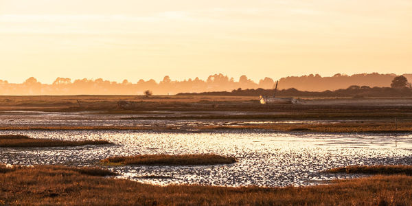 Scenic view of land against sky during sunset