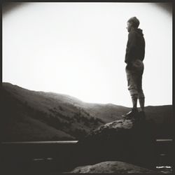 Woman standing by railing