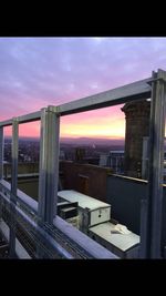 Built structures against sky at sunset