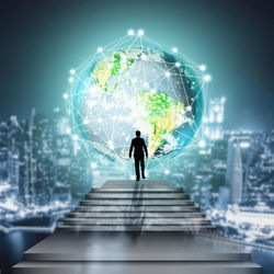 Digital composite image of silhouette businessman leading towards illuminated globe at night