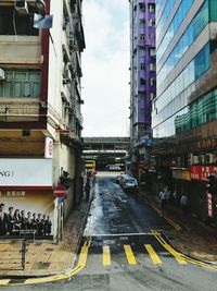 Vehicles on road along buildings