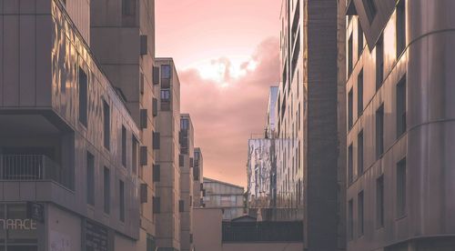 Low angle view of buildings against sky during sunset