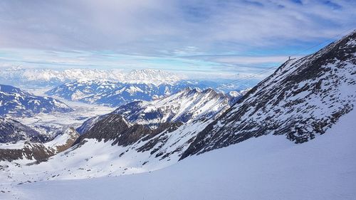 Aerial view of snowcapped mountains against sky