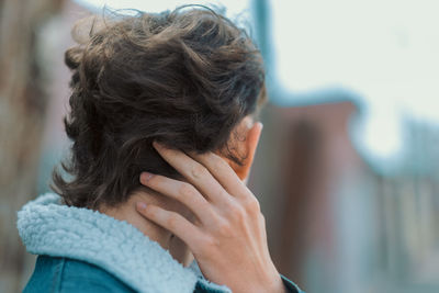 Back portrait of trendy man showing haircut