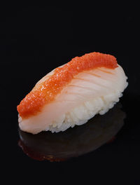 Close-up of sushi against black background