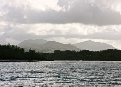 Calm sea against mountain range