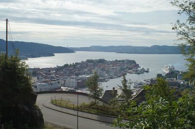 High angle view of city by sea against sky