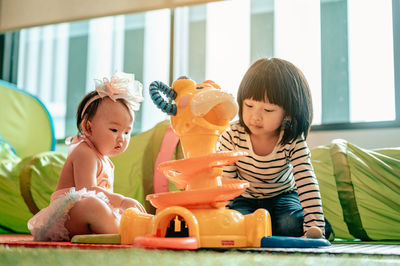 Cute baby girl sitting on table