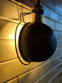 Close-up of light bulb against wall