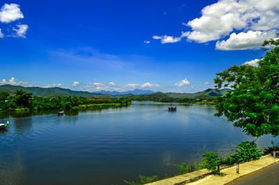 Ferry sailing in river against sky