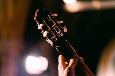 Cropped hand of person playing guitar