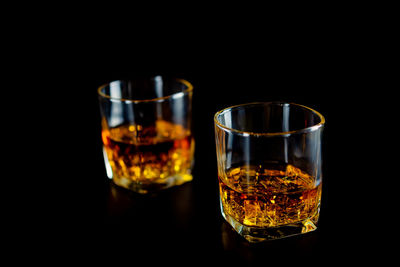 Close-up of beer glass against black background