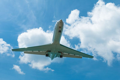 Low angle view of airplane flying against sky