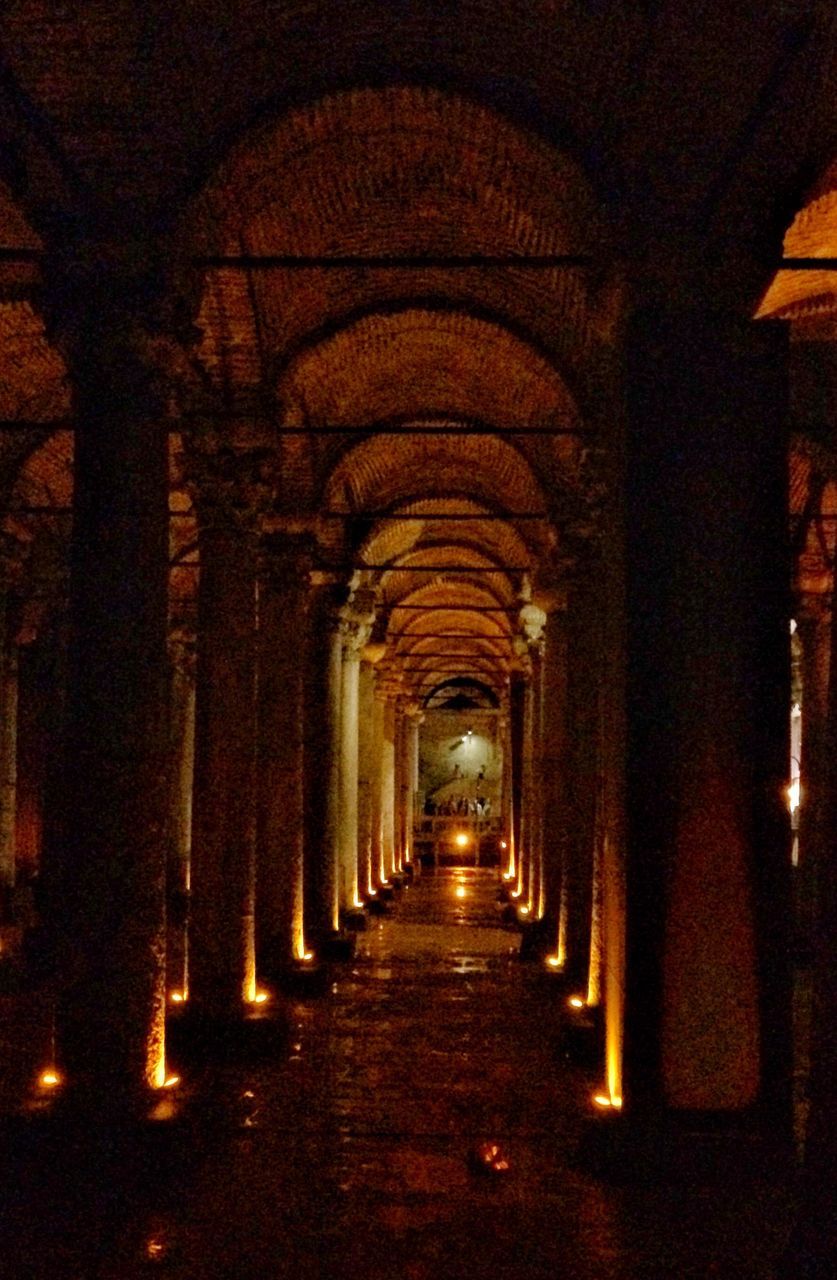 architecture, the way forward, direction, arcade, building, built structure, corridor, arch, illuminated, diminishing perspective, indoors, in a row, architectural column, no people, the past, vanishing point, history, lighting equipment, empty, night, ceiling, colonnade, long, aisle