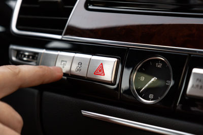 Cropped hand of person holding steering wheel