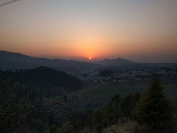 Scenic view of field against sky during sunset