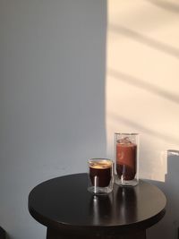 Close-up of tea cup on table against wall