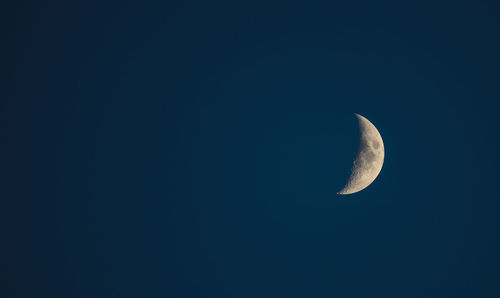 Low angle view of moon in sky at night