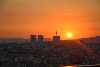 Cityscape against sky during sunset