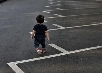 Boy playing on zebra crossing