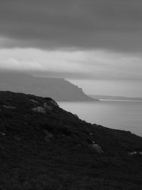 Scenic view of sea and mountains against sky