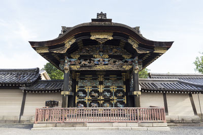 The nishi hongan-ji temple in kyoto, japan may 19th 2016. view of the wooden and carved karamon gate
