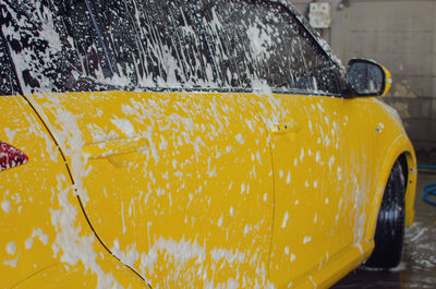 Close-up of wet yellow car