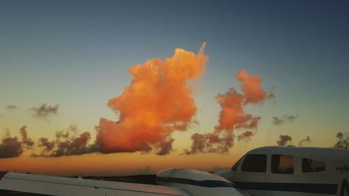 Built structures against sky at sunset