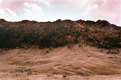 Scenic view of arid landscape against sky