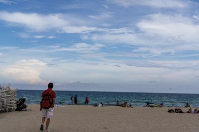 People on beach against sky