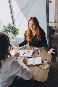 Portrait of woman sitting on table