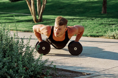 Muscular man exercising at park