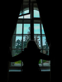 Man looking through window