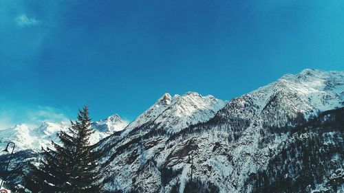 Low angle view of mountains against blue sky