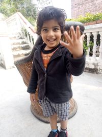 Portrait of smiling boy standing outdoors